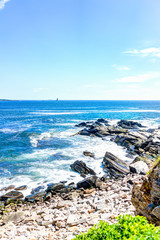 Cliff rocks aerial view by trail by Portland Head Lighthouse in Fort Williams park in Cape, Elizabeth Maine during summer day