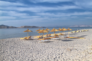 Umbrellas from reed on the evening beach of the island of Kos