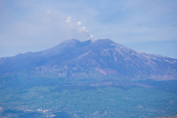 Panoramic view of Etna volcano and beautiful town of Taormina in the foreground, Sicily island, Italy