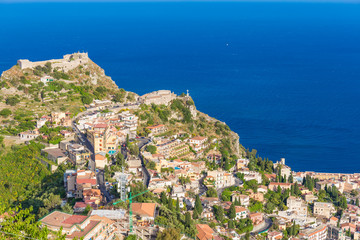 Naklejka na ściany i meble Panoramic view of small Village of Castelmola, overlooking town of Taormina with sea background, Sicily island, Italy