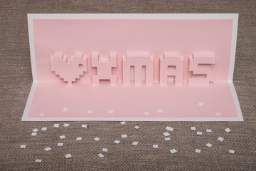 Homemade pop-card  Merry Christmas on rough fabric.