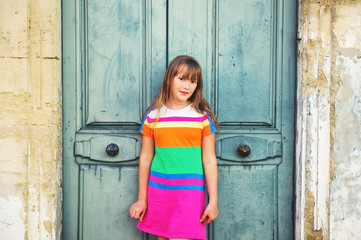 Outdoor portrait of adorablr preteen kid girl wearing colorful summer dress
