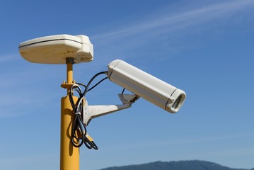 CCTV camera against a blue sky