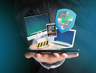 Shield symbol surrounded by padlock and devices displayed on a futuristic interface - Security and internet concept