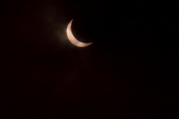 Obraz na płótnie Canvas 70 percent solar eclipse on cloudy day in Iowa
