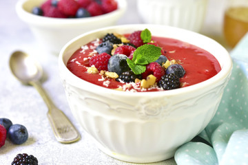 Strawberry smoothie bowl with fresh fruits and berries.