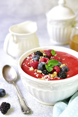 Strawberry smoothie bowl with fresh fruits and berries.