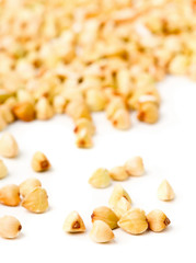 Macro of raw, natural, uncooked buckwheat seed kernels on white background
