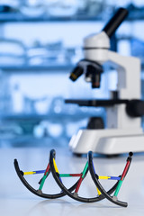 Microscope with dna model in lab