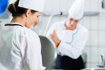 Commercial kitchen with chefs cooking