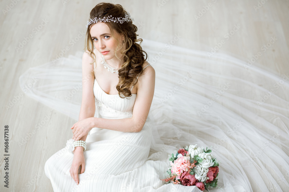 Wall mural Brunette bride in fashion white wedding dress with makeup - Wall murals