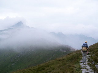 A traveler with a backpack. Morning misty mountain. Hiking.