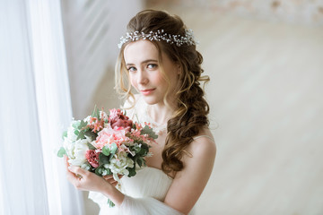 Brunette bride in fashion white wedding dress with makeup