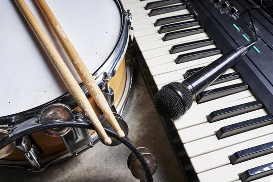 group of musical instruments including a drum and keyboard