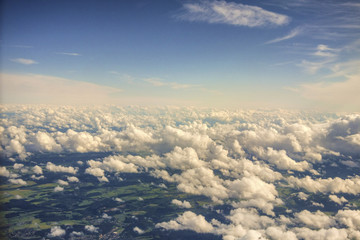 View from above the clouds. Flying over clouds in plane. Over clouds view.