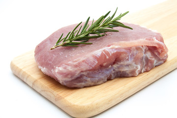 pieces of raw pork steak with spices and herbs rosemary