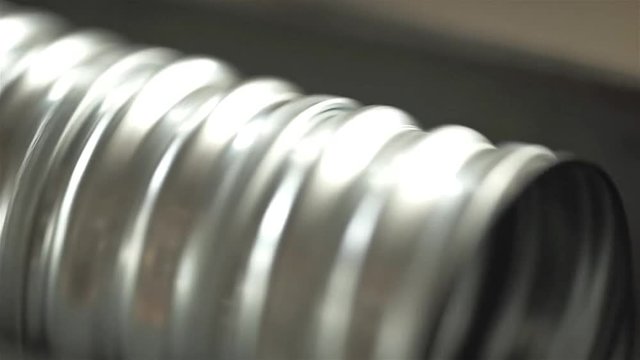 Aluminum Duct Pipe Circling On A Machine - Close Up 