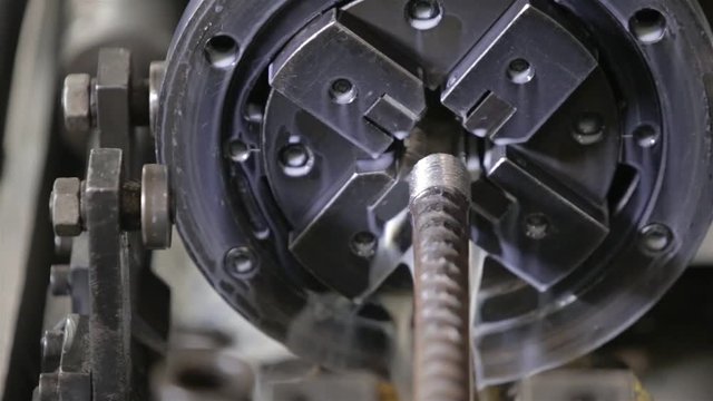 Steel Bar Being Cut In Machine Going In Circles With Water -  Close Up