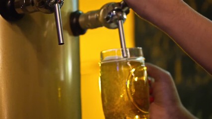 A Girl Filling Up Beer From A Barrel - Close Up -  Focus Pull 