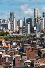 Social inequality in Salvador city: Favela and buildings. Vertical photo