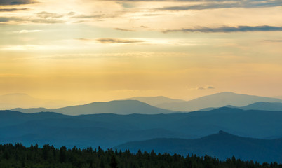 Fototapeta na wymiar Sun rays at dawn over the mountain range.