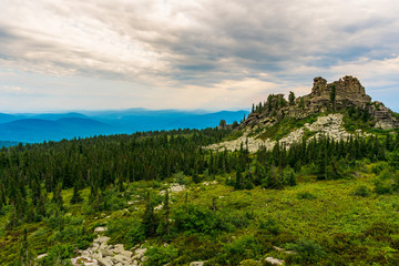 Flying clouds over the rocks and mountain range
