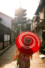 Japanese girl in Yukata with red umbrella in old town  Kyoto