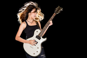 Young and beautiful rock girl playing the electric guitar