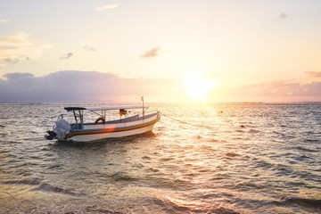 Stunning beautiful sunlight beach with fishing boats on a beach. Sanur Beach, Bali, Indonesia.