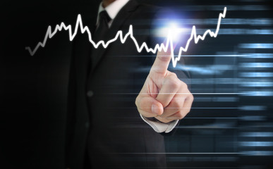hand with stock financial chart symbols coming from hand