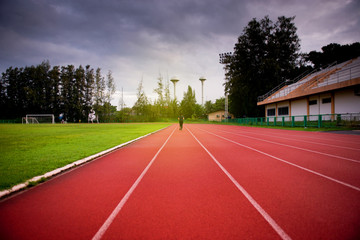 Red running track in stadium,running track on blue sky in the morning