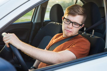 Tourist guy in car. Travel and summer vacation concepts.