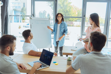 Nice smart woman pointing at the whiteboard