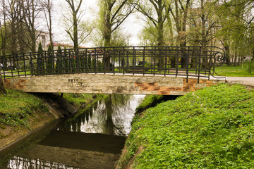 Fototapeta na wymiar Little bridge over the creek in the park
