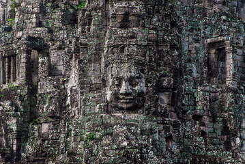 Fototapeta premium Prasat Bayon with smiling stone faces is the central temple of Angkor Thom Complex, Siem Reap, Cambodia. Ancient Khmer architecture and famous Cambodian landmark, World Heritage.