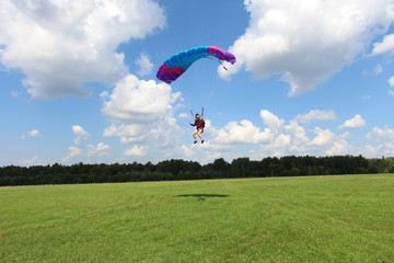 Skydiver girl is landing.