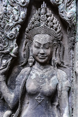 Fototapeta na wymiar Detail of stone carvings of Apsara is a beautiful and seductive girl of Hindu mythology at Angkor Wat, Cambodia