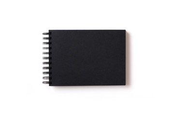 Horizontal aligned isolated sketchbook mock up with blank black paper on white background. Top view, flat lay.