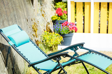 Blue sunbed deck chair in garden