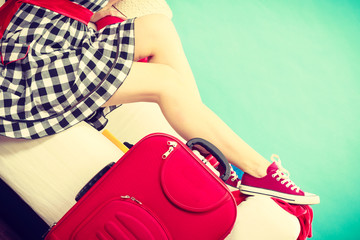 Woman relaxing after packing suitcase for vacation