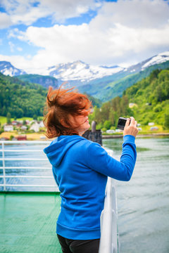 Tourist woman on liner taking photo, Norway