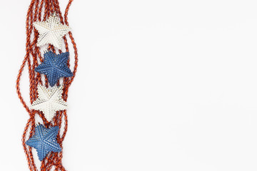 Beautiful white and blue christmas decoration stars with red ribbons on white background