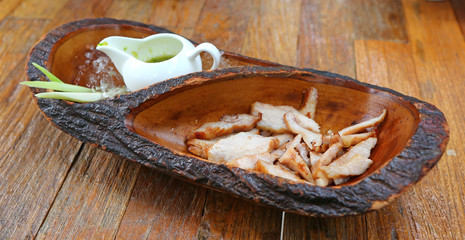 Grilled Pork in wood plate, Thai food style.