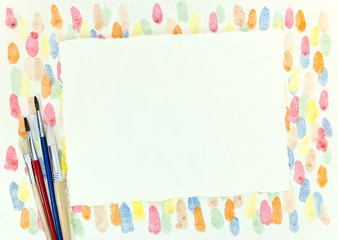 decorative chaotic colorful blobs texture and various paintbrushes with empty paper sheet