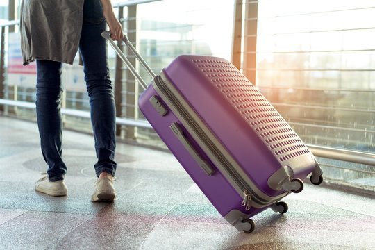 Young girl traveler walking with carrying hold suitcase luggage and passenger for tour travel booking ticket flight in airport international vacation time in holiday rest and relaxation.