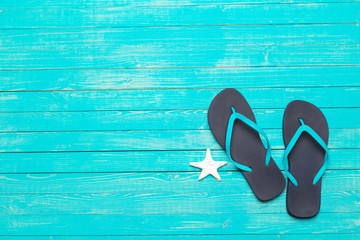 flip-flops on color wooden background