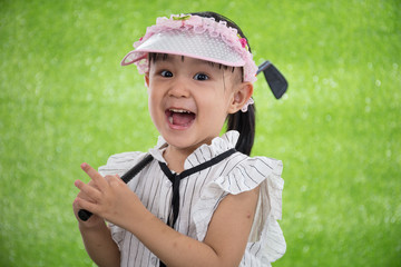 Asian Chinese little girl playing golf - Powered by Adobe