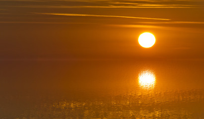 Blurred image of reflections of sun light on a water surface with absolute tranquillity - Soft focus