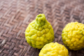 Kaffir Lime On Wickerwork / Yellow Of Kaffir Lime On Wickerwork Bamboo Background.