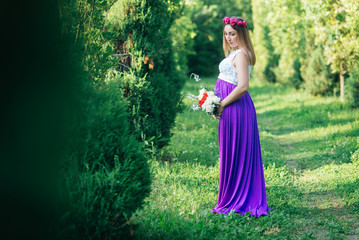 Fototapeta premium Beautiful pregnant woman in the park